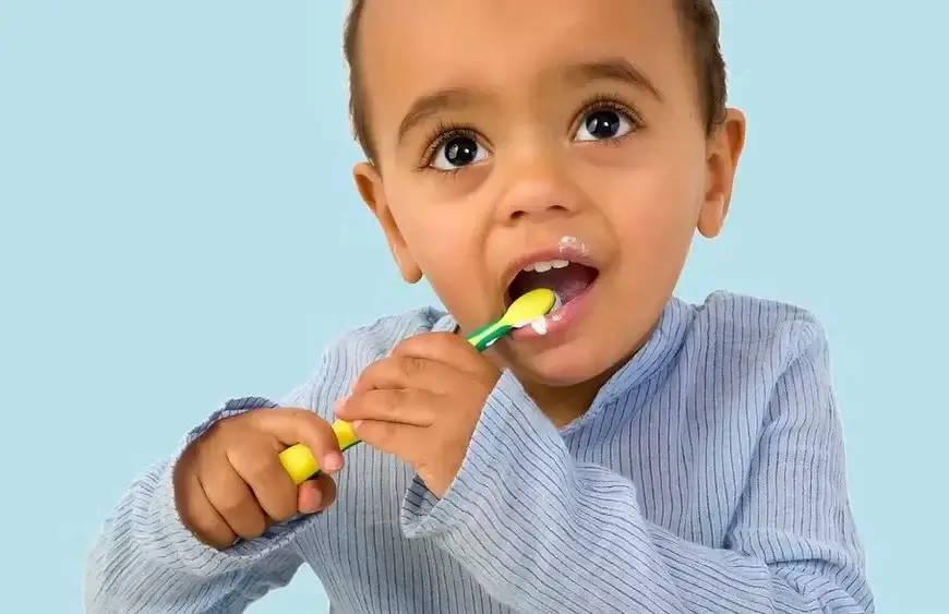 A little boy brushes his teeth