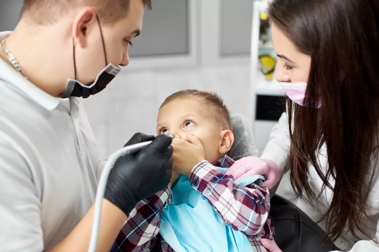 Smiling child in dental chair before pediatric sedation