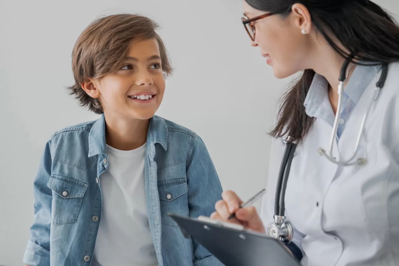 Child meeting with a pediatric healthcare provider during a consultation