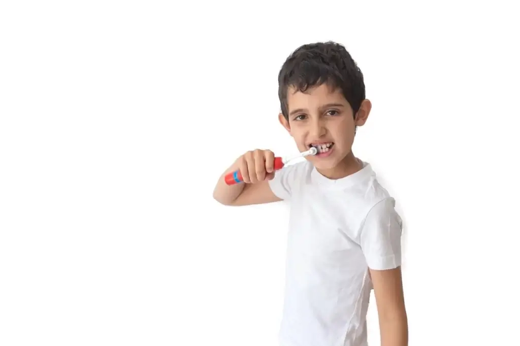 Child brushing teeth with an electric toothbrush