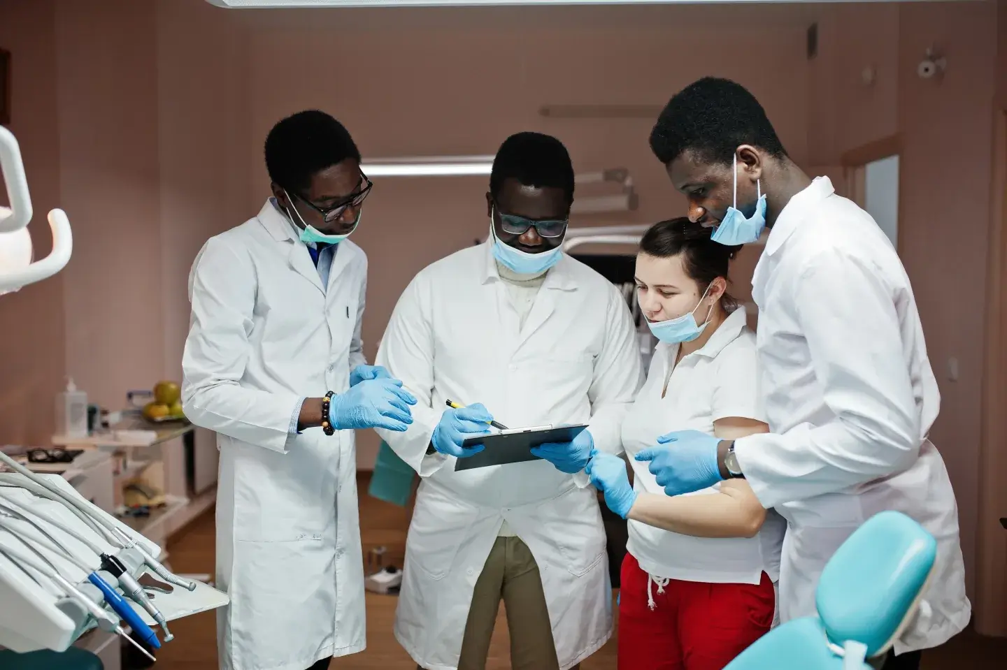 Multiracial dental team discussing a pediatric sedation referral