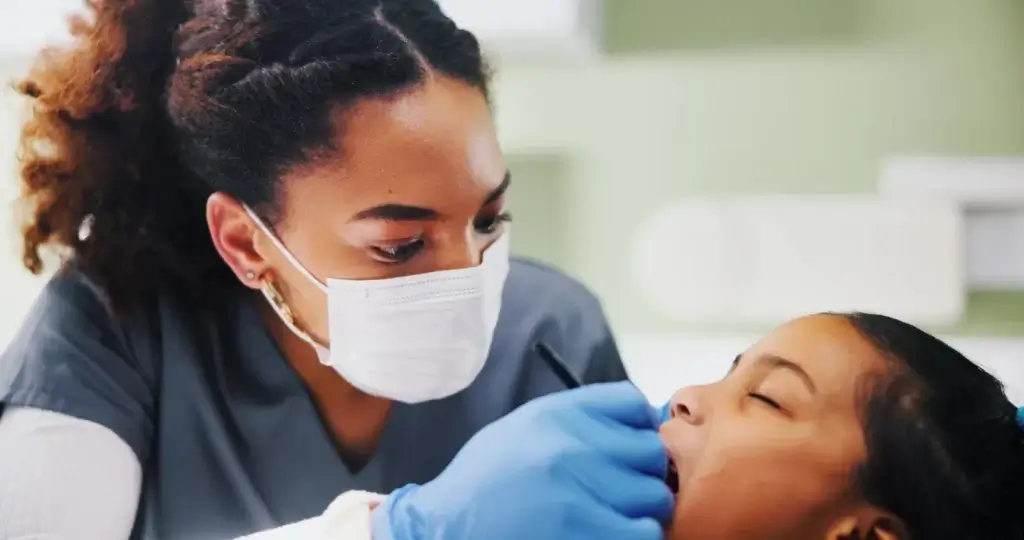 Calm child receiving an examination in a pediatric dental clinic